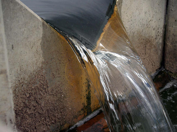 free-spilling discharge over a stainless steel v-notch weir