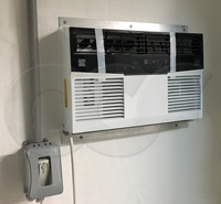 thru-wall air conditioner mounted on a fiberglass equipment shelter building